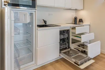 a kitchen with an empty refrigerator with its door open at Modern Loft Apartment with free parking No4 in Marijampolė