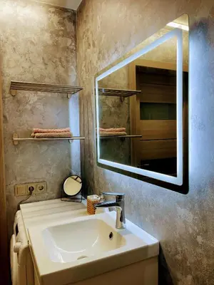 a bathroom with a sink and a mirror at Family room in Vilnius
