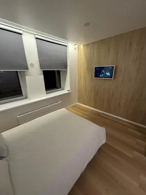a bedroom with a bed and two windows in it at 9 New Airport Apartment in VNO