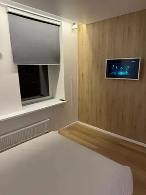 a bedroom with a flat screen tv and a bed at 9 New Airport Apartment in VNO