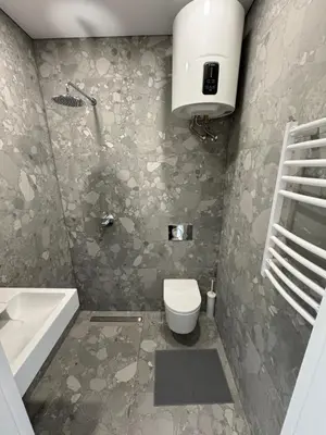 a bathroom with a toilet and a sink and a tub at 9 New Airport Apartment in VNO