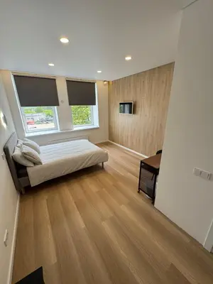 a bedroom with a bed and a window and a desk at 10 New Airport Apartment in VNO