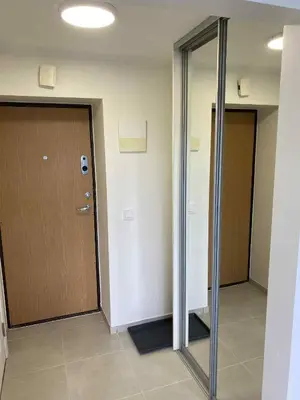 an empty hallway with a door and a mirror at Vilnius Apartment with Balcony in Vilnius