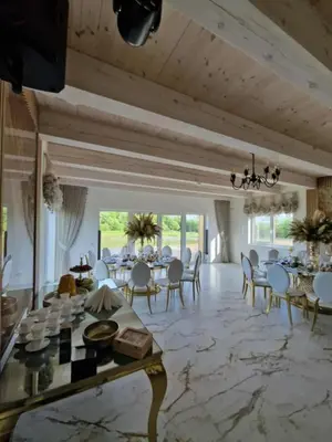 a large dining room with a table and chairs at Baltasis beržas