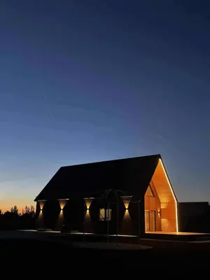 a building with lights on the side of it at Modern design in quiet nature