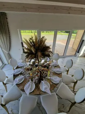 a dining room with a table and white chairs at Modern design in quiet nature