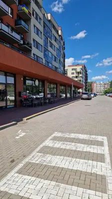 an empty parking lot in front of a building at Apartamentai Vilnius Lazdynėliai in Vilnius