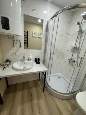 a bathroom with a sink and a shower at Florina namai in Marijampolė