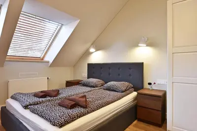 a bedroom with a large bed with pillows on it at Domillion New modern Vilnius old town studio U2303 in Vilnius