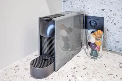 a toaster oven sitting on a counter next to a glass container at Domillion 2bdr Modern Old Town Retreat So1d in Vilnius