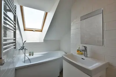 a white bathroom with a sink and a bath tub at Domillion Pylimo Penthouse duplex apt 15ppl P36D in Vilnius
