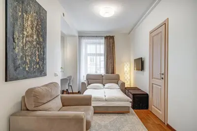 a living room with a couch and a chair at Domillion New Old Town Amber 1bdr Z1B4 in Vilnius