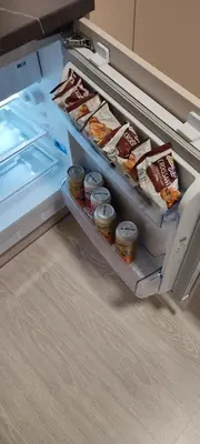 an open refrigerator with some food in it at SimpleStayVilnius in Vilnius