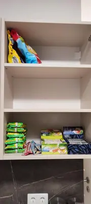 a shelf filled with different types of cloths at SimpleStayVilnius in Vilnius