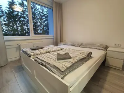 a white bed in a room with a window at Rasa in Marijampolė