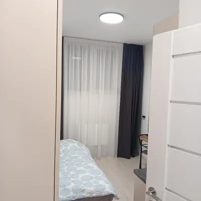 a mirror in a room with a bed at VilniusCentralSpot in Vilnius