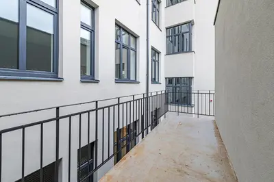 a walkway between two buildings with windows at Vytauto 43 Residence – Lietūkis by Domvia in Kaunas