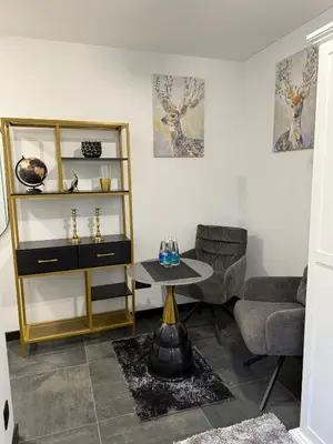 a living room with a chair and a table at Flat In the heart of Kaunas city center in Kaunas