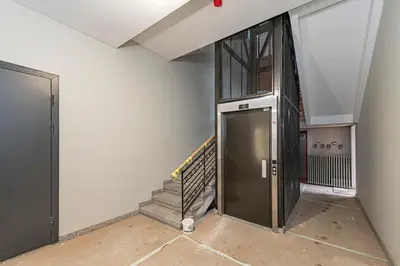 a hallway with a door and stairs in a building at Vytauto 43 Residence 4 by Domvia in Kaunas