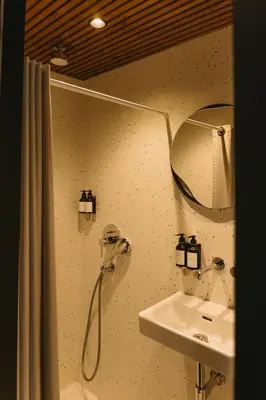 a bathroom with a shower and a sink at Blackview cabin in Kulautuva