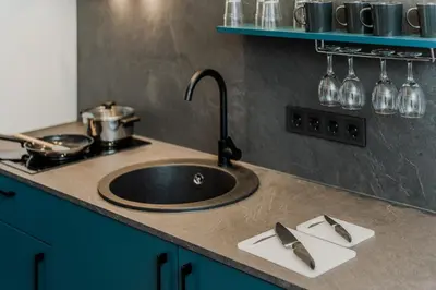 a kitchen counter with a sink and a stove at Chamber House in Kaunas