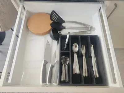 a drawer filled with utensils and utensils at Cozy Apartment for Rest & Creativity 6 in Vilnius