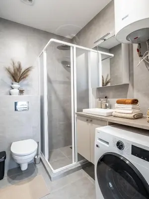 a bathroom with a shower and a washing machine at Šopeno Butas Cozy Quiet and Well-Located 5 in Vilnius