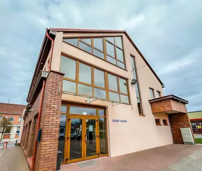 a building with glass doors on the side of it at Keta in Marijampolė