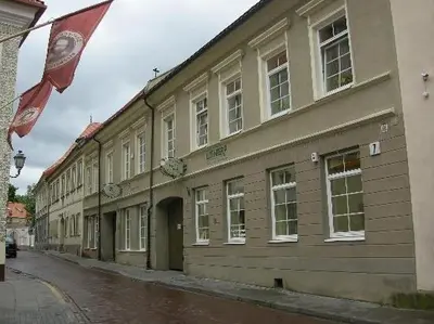 a building with a flag on the side of a street at Litinterp Host in Vilnius