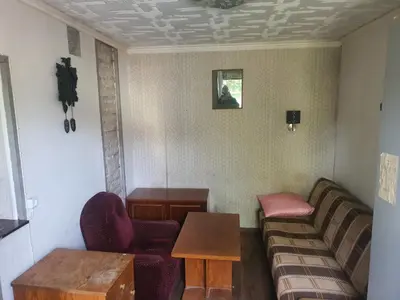 a living room with a couch and a table at Hostel in Rudamina