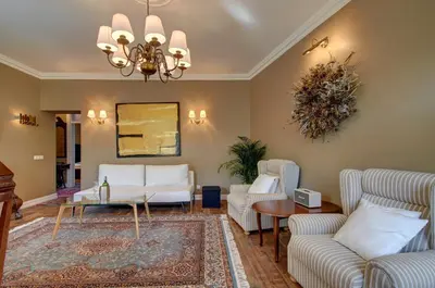 a living room with white furniture and a chandelier at German18-3B Luxury Vilnius apartment in Vilnius
