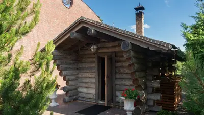 an outside view of a log cabin with a door at Harmony Park Countryside Villas & SPA in Prienai