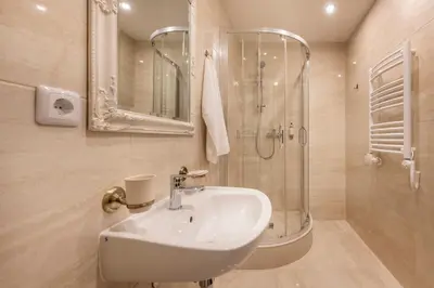 a bathroom with a sink and a shower at Kesminta Apartments in Vilnius