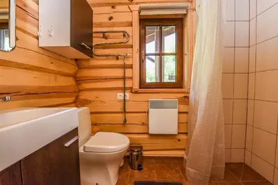 a bathroom with a toilet and a sink at Mekų slėnis in Degučiai