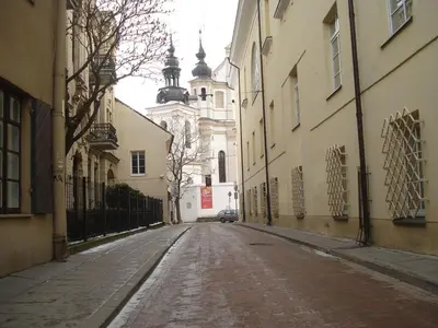 an empty street in a city with a building at Cozy Apt in the Heart of Old Town in Vilnius