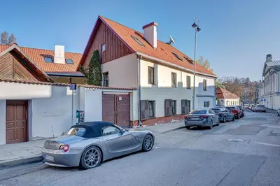 a silver car parked on the side of a street at Vidos apartamentai 2 in Vilnius