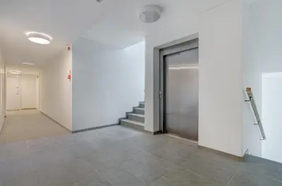a hallway with a door and stairs in a building at Center Apartment 10A in Vilnius
