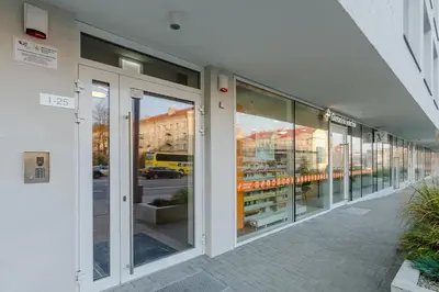 a row of glass doors of a building at Center Apartment 10A in Vilnius