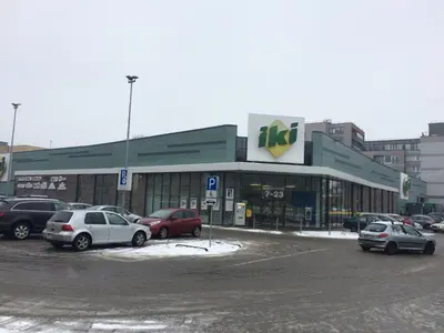 a parking lot with cars parked in front of a store at Spacious apartment close to the Old Town in Vilnius