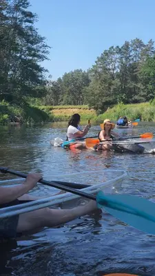 a group of people kayaking on a river at VIP Green House of Hope for 2 in Leliūnai