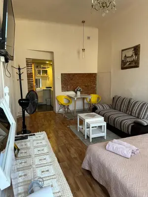 a living room with a couch and a table at Gediminas apartment in Kaunas