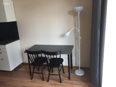 a black table with two chairs and a lamp at Near PANORAMA apartment Self check-in Garage free in Vilnius