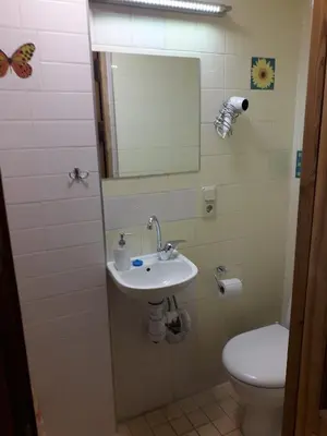 a bathroom with a sink and a toilet at Small room with a private external bathroom in Kaunas