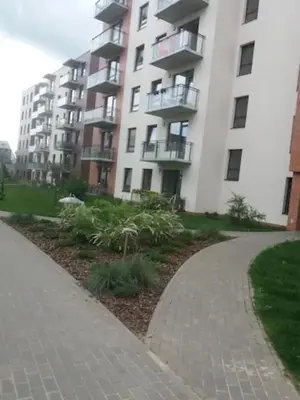 a walkway in front of a large apartment building at Close to PANORAMA center apartment Self check-in Garage free in Vilnius