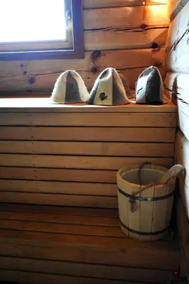 a pair of shoes sitting on a shelf in a cabin at Kaimukas - namelis prie ežero keturiems in Dvarčėnai