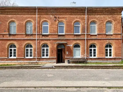a large brick building with a door in front at Traukinių namai #2 in Švenčionėliai