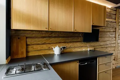 a kitchen with wooden cabinets and a sink at Apartments in Kaunas in Kaunas