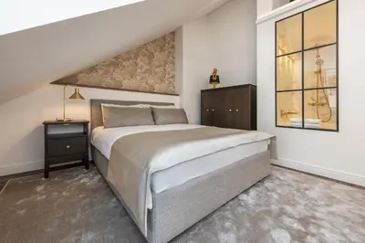 a bedroom with a large bed and a window at Artsy Exclusive Old Town Residence Gallery Walk in Vilnius