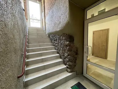 a staircase leading to a door in a building at Modern guest house in city center I Room 3 in Vilnius