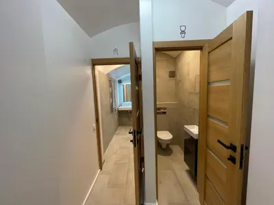 a small bathroom with a toilet and a door at Modern guest house in city center I Room 2 in Vilnius